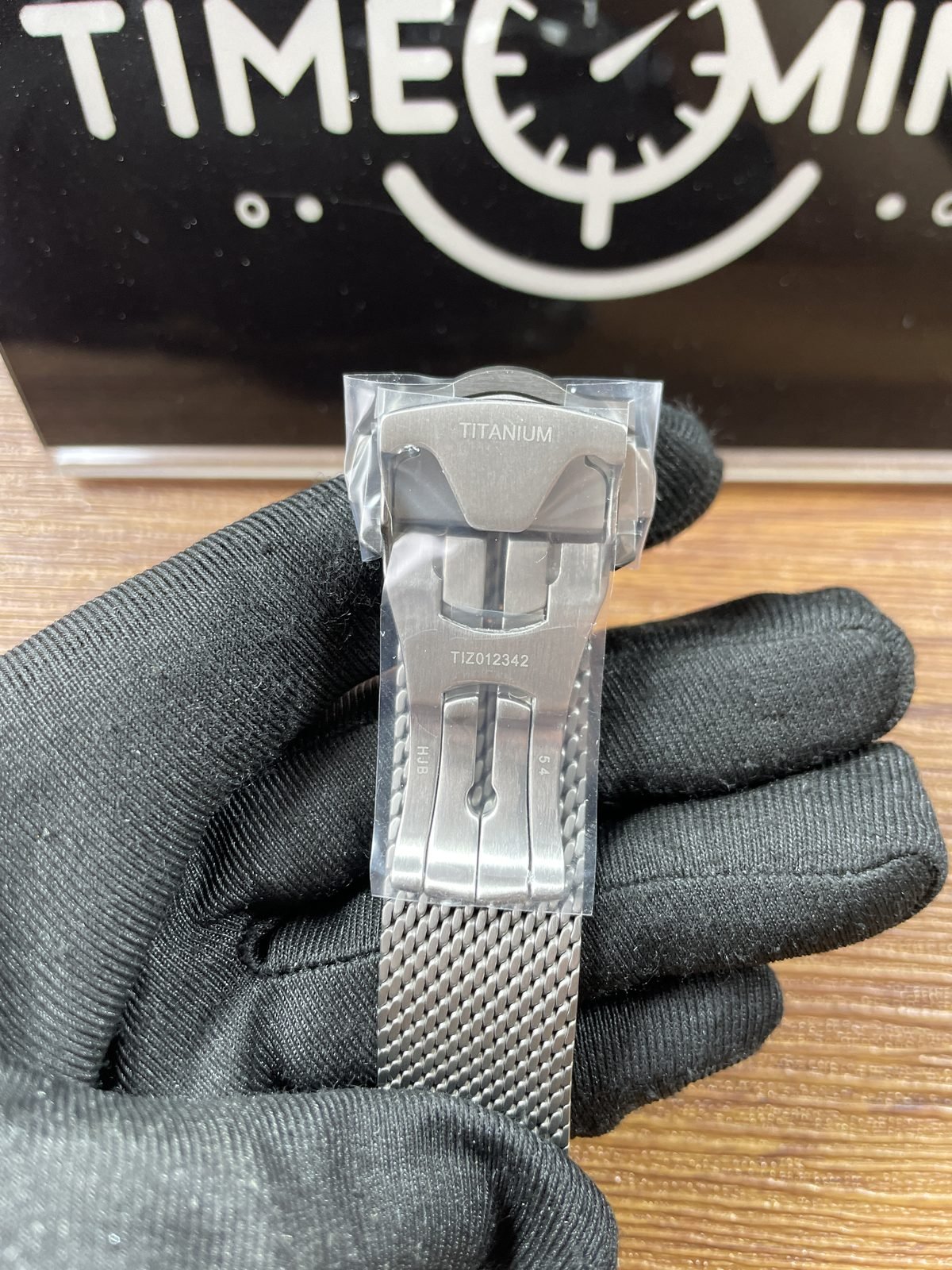 Filmed underside of mesh bracelet folding clasp with TITANIUM TIZ012342 HJB and 54 style markings