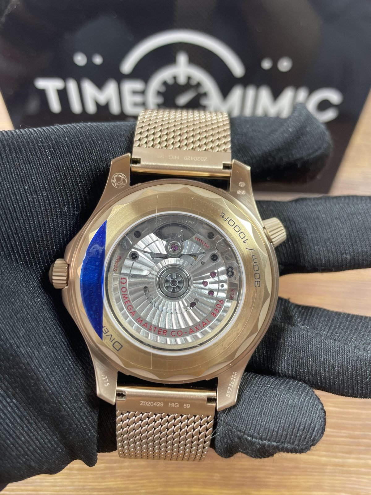 Transparent back of warm tone Seamaster replica showing decorated automatic looking movement and 8806 style text