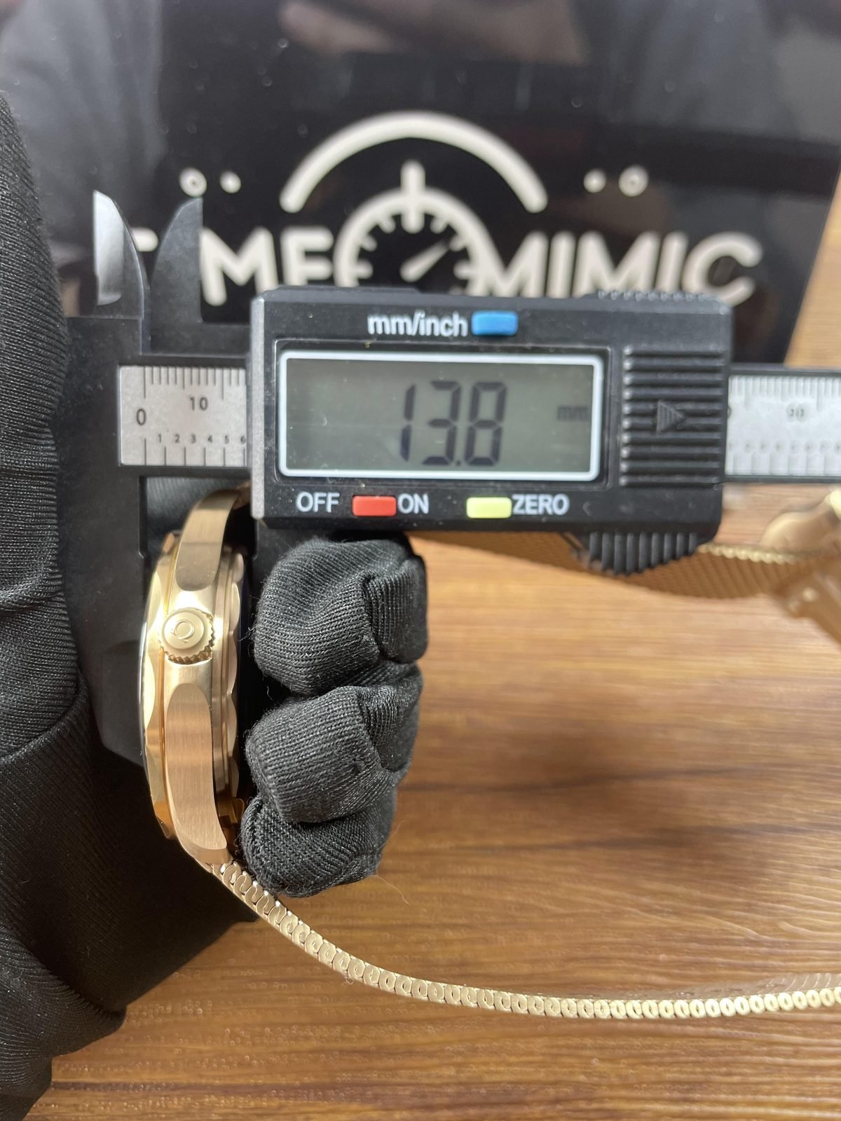Digital calliper displaying about 13.8 millimetres in thickness direction of warm tone Seamaster replica