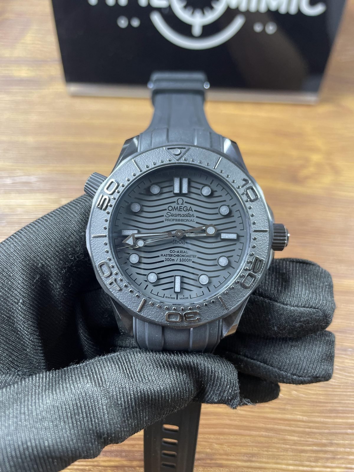 Black Black style Omega Seamaster 210.92.44.20.01.003 replica front with no-date wave pattern dial black grey bezel and rubber strap