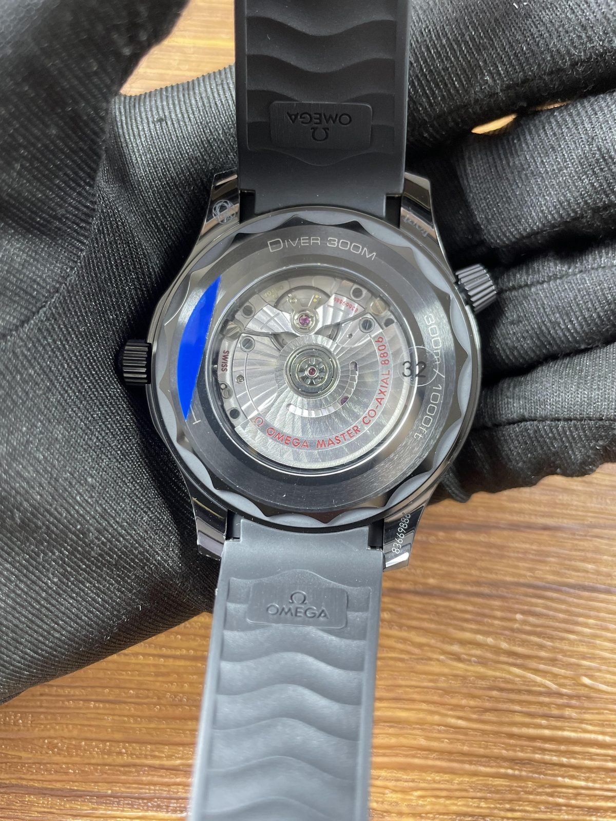 Transparent wave edged back of Black Black style Seamaster replica with decorated automatic looking movement and 8806 style text
