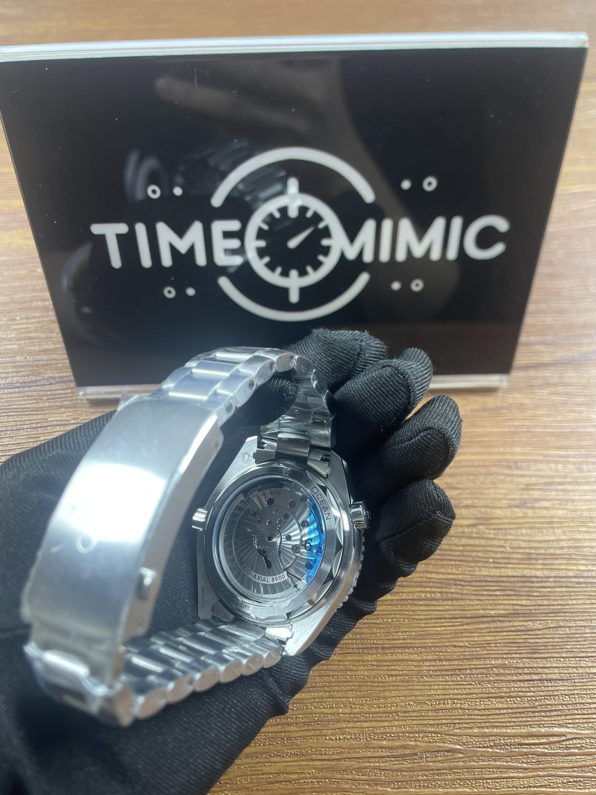 Transparent back of Planet Ocean style replica showing decorated automatic looking movement and 8900 style wording