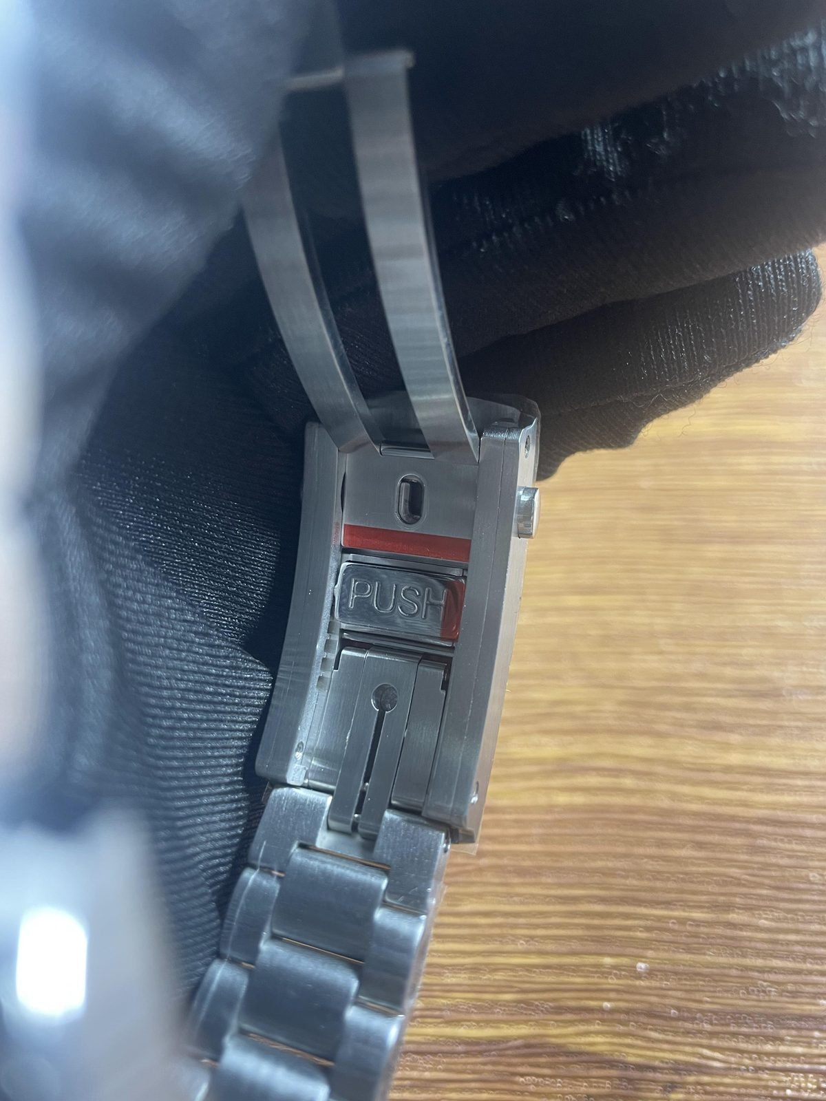 Open foldover clasp interior of Planet Ocean replica with PUSH style label and extension looking hardware
