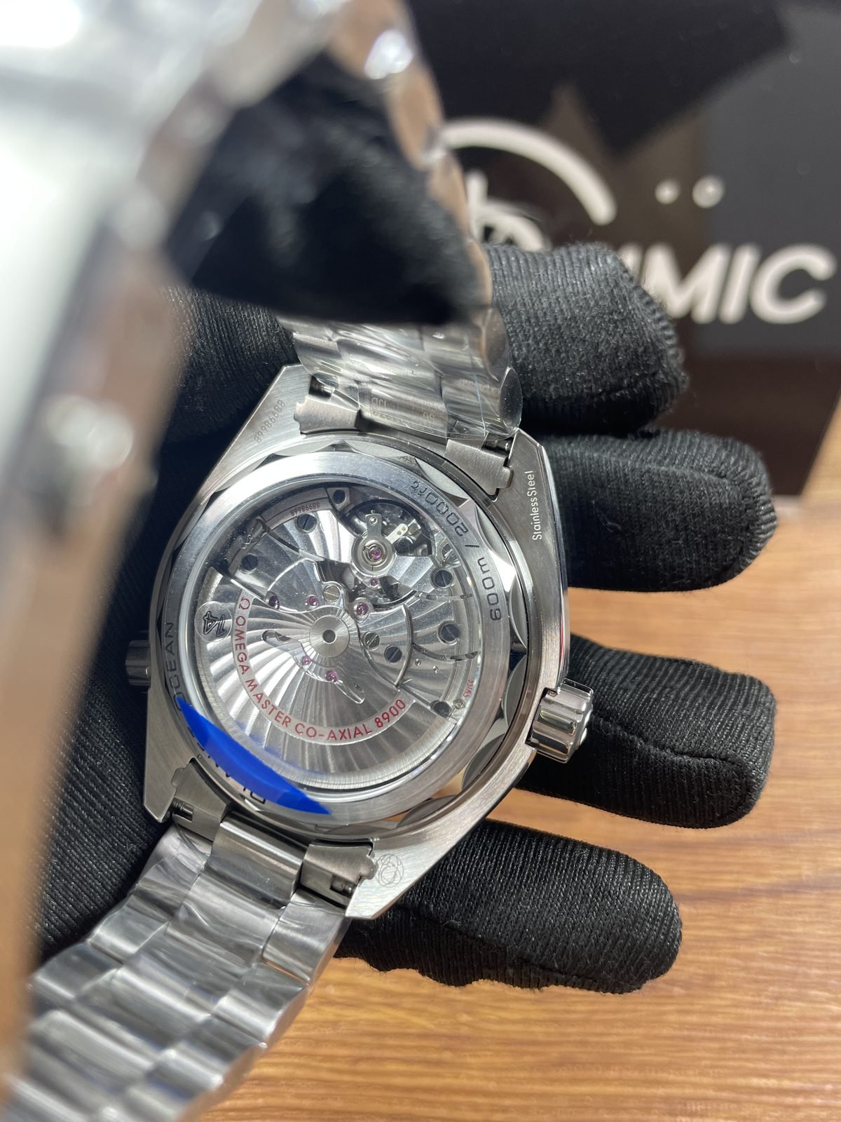 Close transparent caseback of Planet Ocean replica with 8900 Planet Ocean stainless steel and 600m style markings