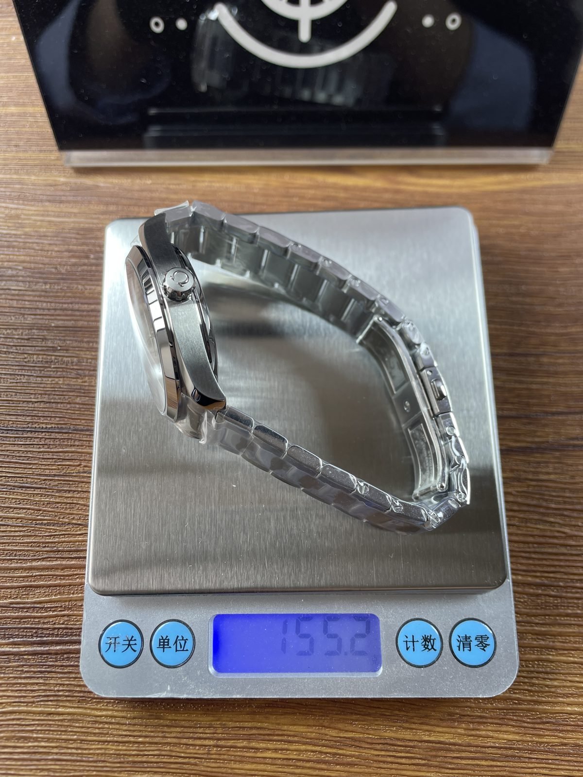 Black dial Aqua Terra replica on digital scale displaying about 155.2 grams