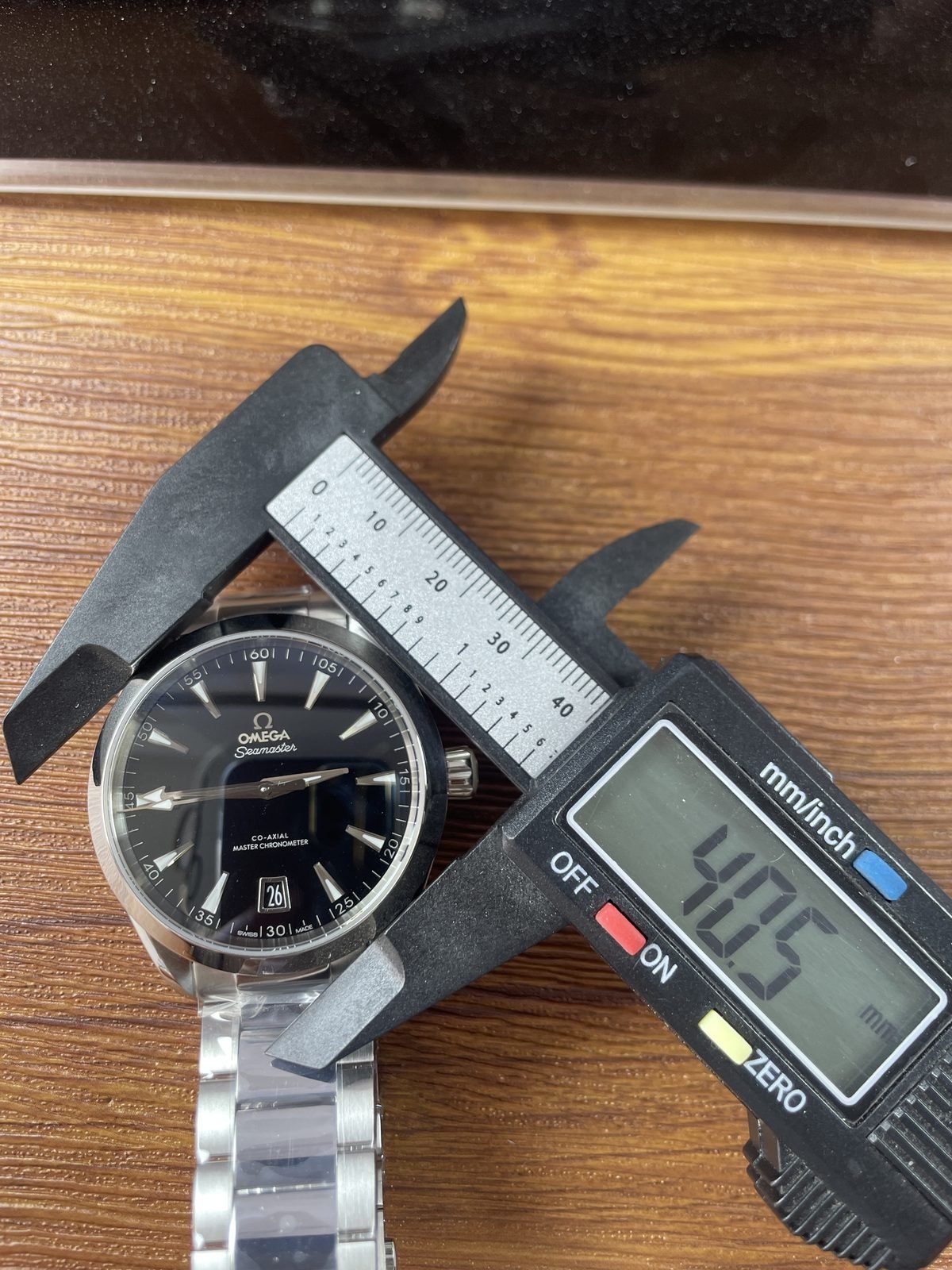 Digital calliper displaying about 40.5 millimetres across the case body of black Aqua Terra replica