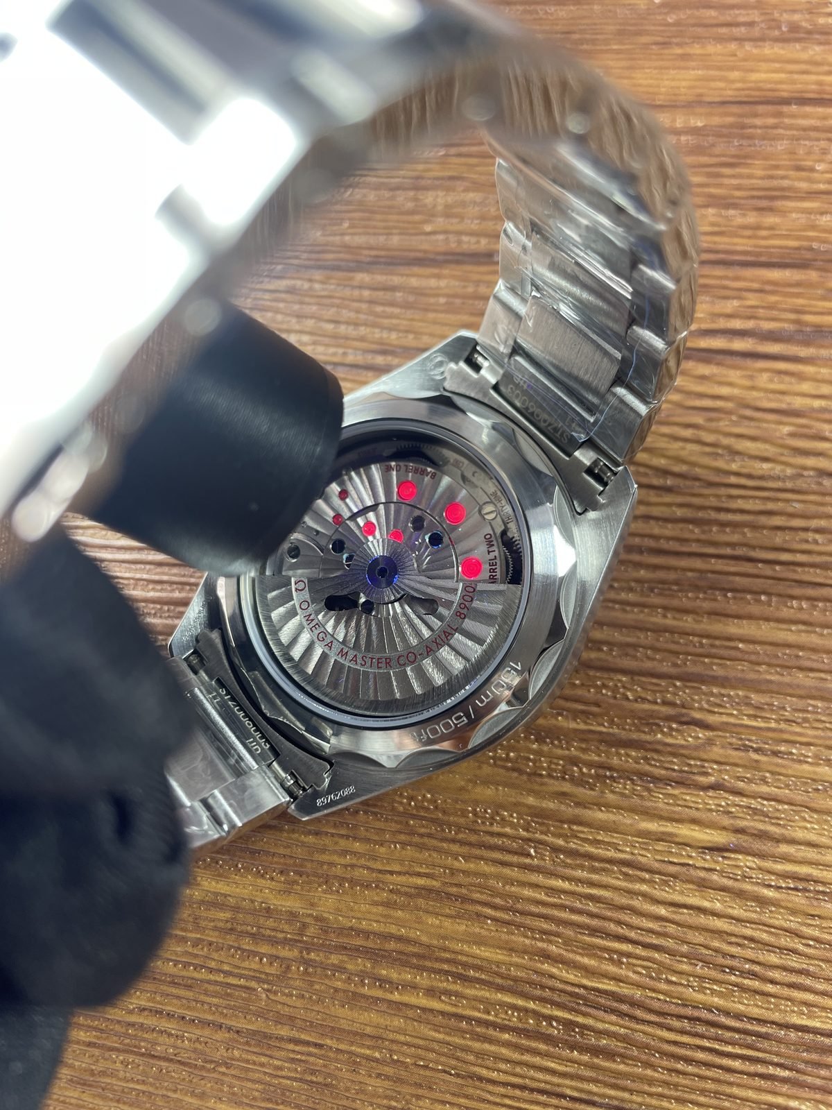 Illuminated transparent back of Aqua Terra replica with barrel 8900 150m and code style markings