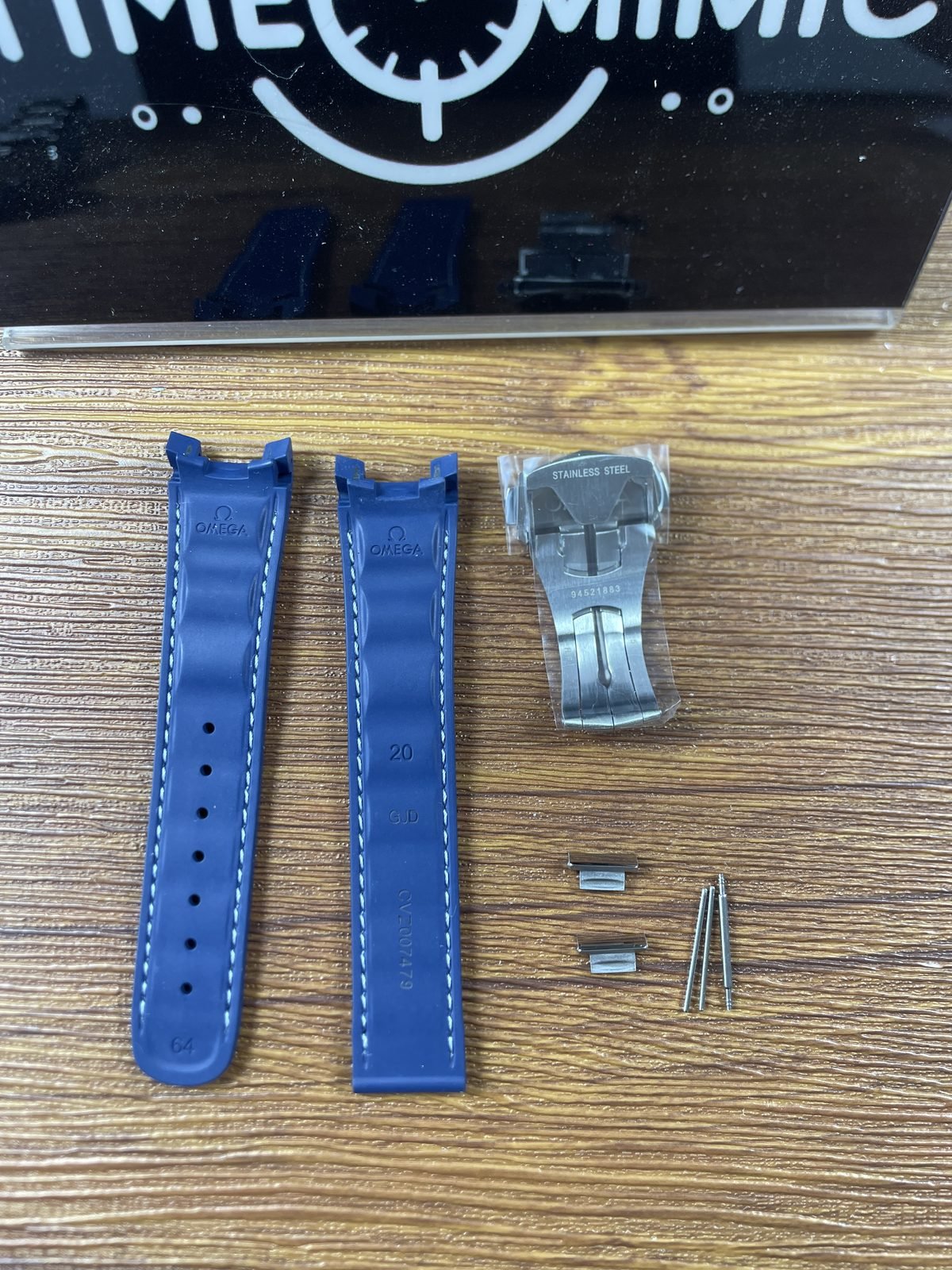 Blue strap undersides and clasp with Omega 20 GJB 64 YF2001779 stainless steel and 94521883 style marks