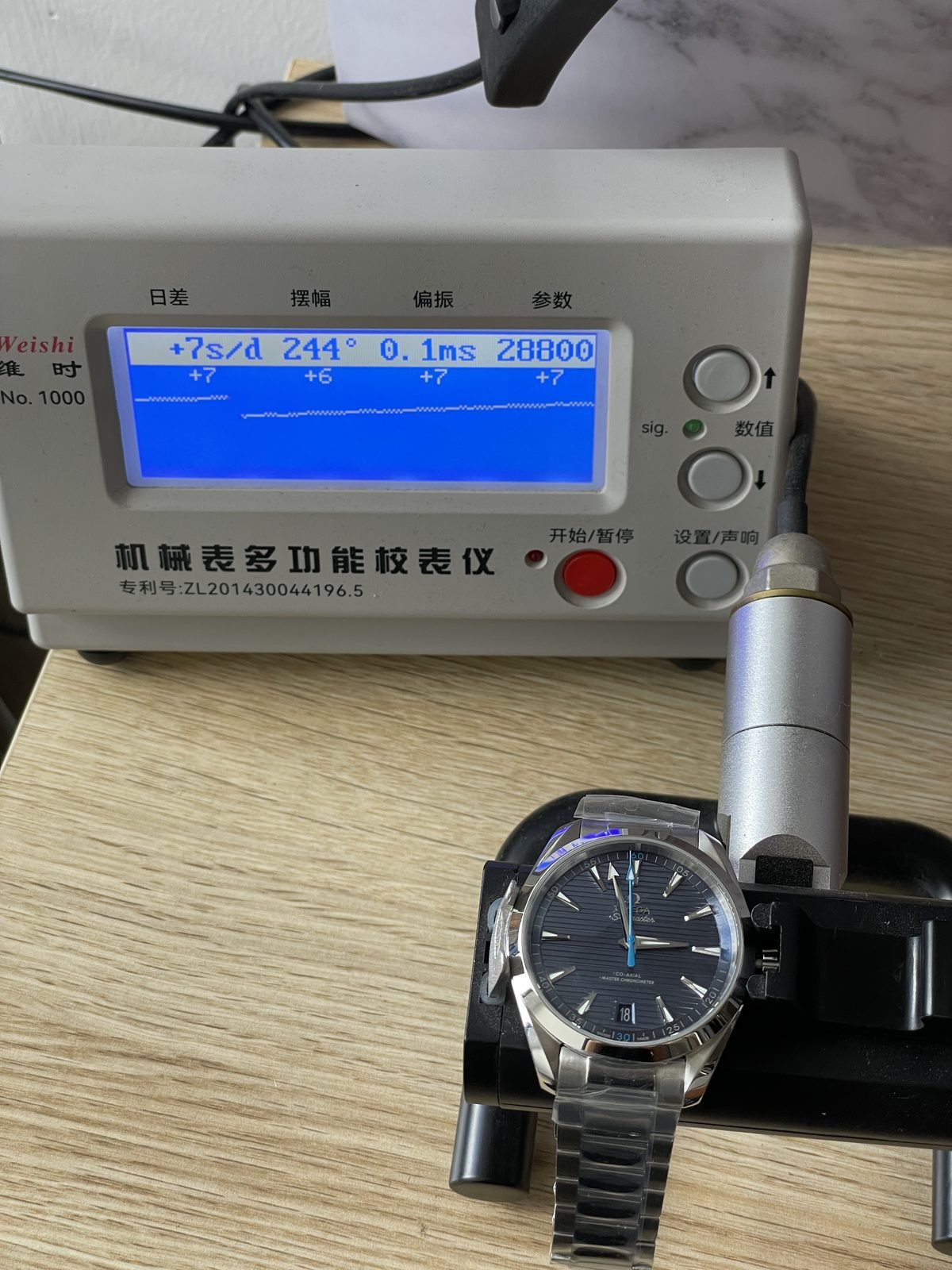 Blue Aqua Terra replica on timegrapher displaying about plus 7 seconds per day 244 degrees 0.1 milliseconds and 28800
