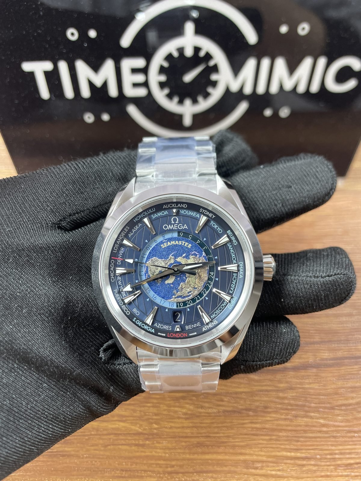 Blue Aqua Terra Worldtimer replica with central world map city ring 24 hour scale date 2 and steel tone bracelet