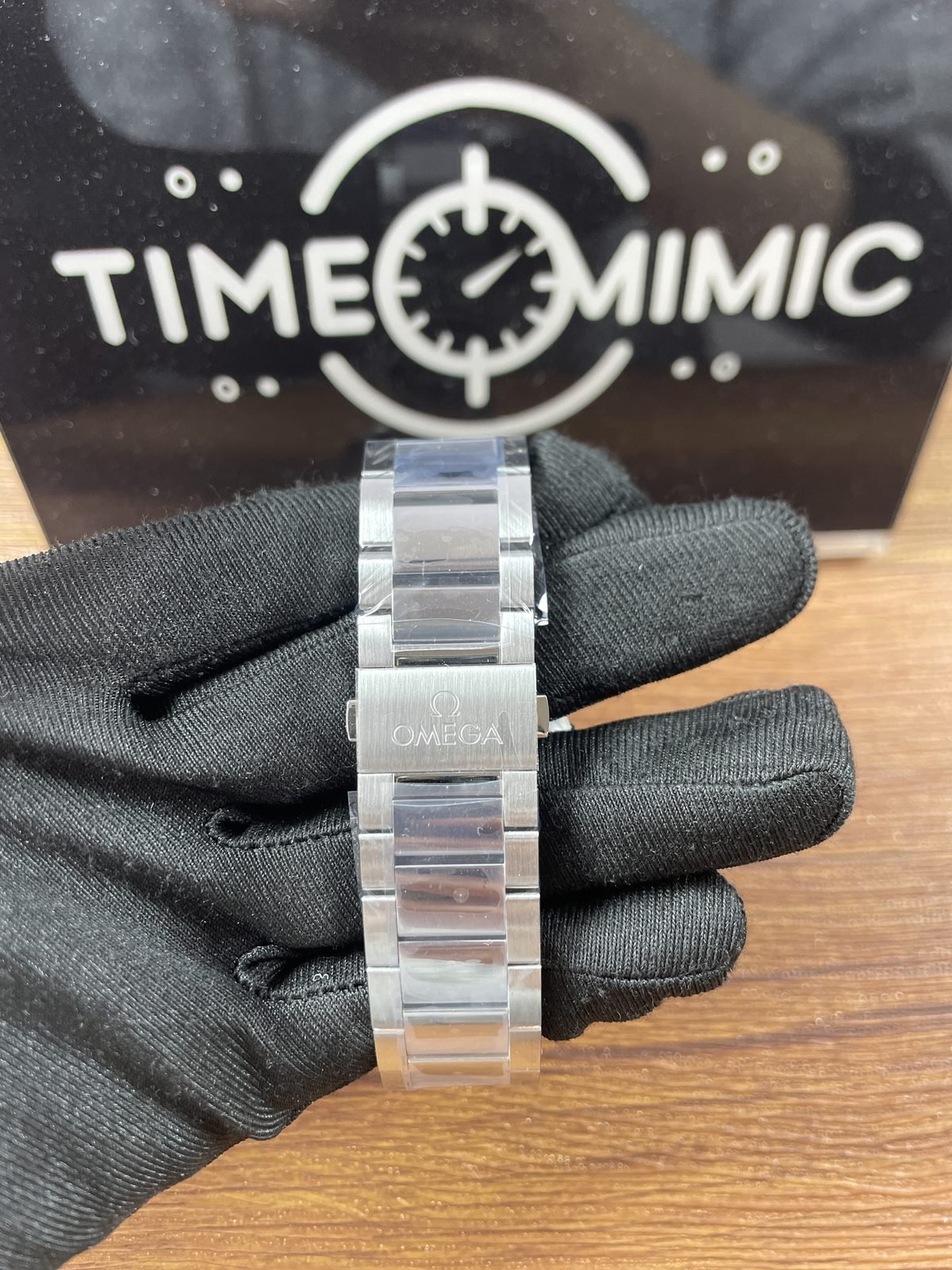 Steel tone bracelet clasp exterior of Aqua Terra Worldtimer replica with Omega style logo