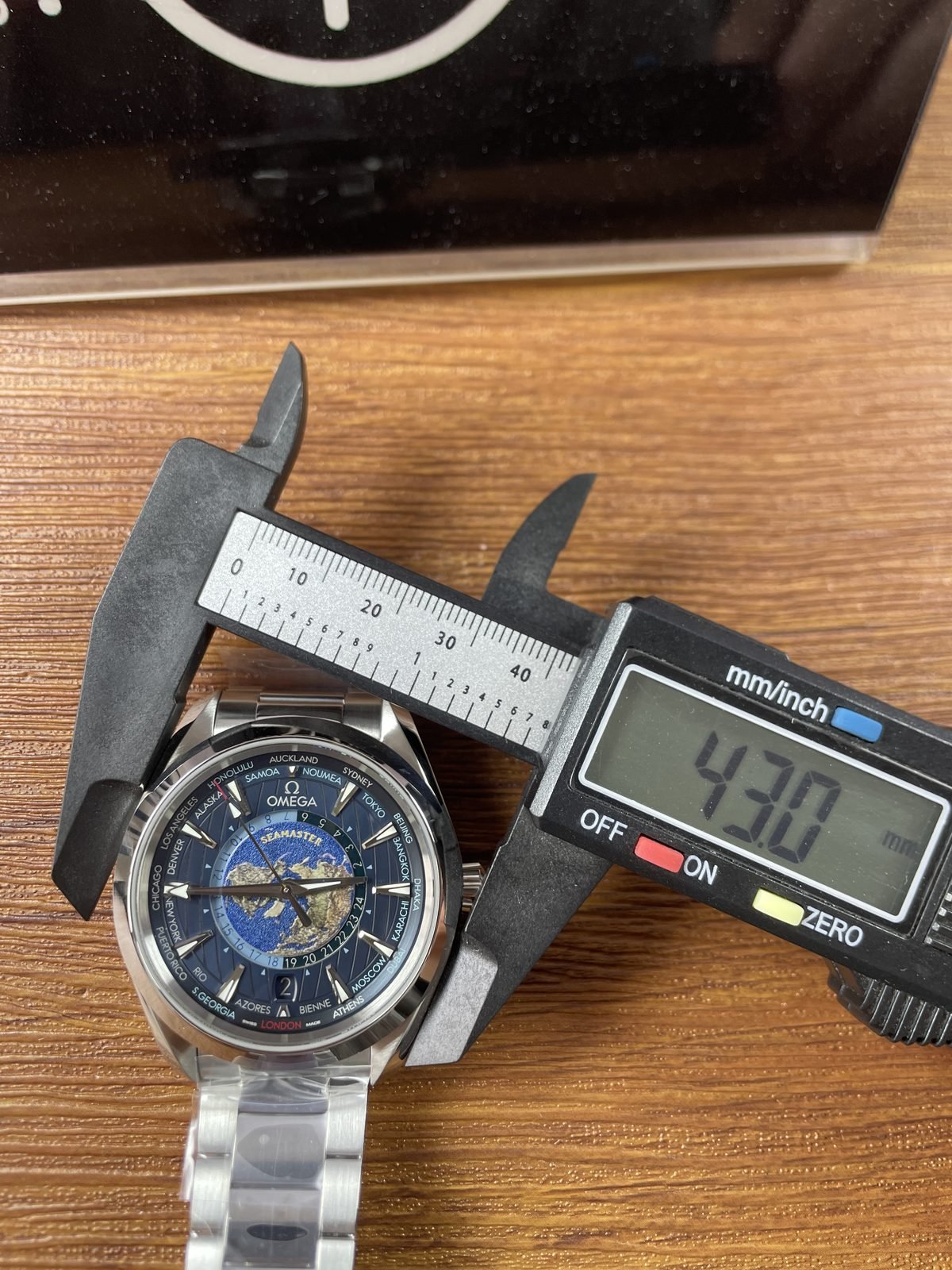 Digital calliper displaying about 43.0 millimetres across the case body of Aqua Terra Worldtimer replica