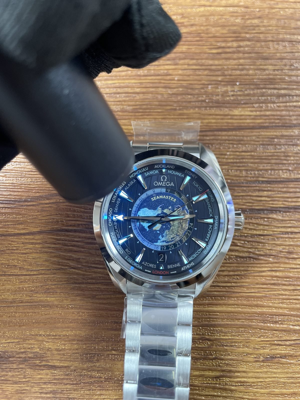 Blue Aqua Terra Worldtimer replica showing immediate blue cyan luminous style response on hands indexes and dial areas