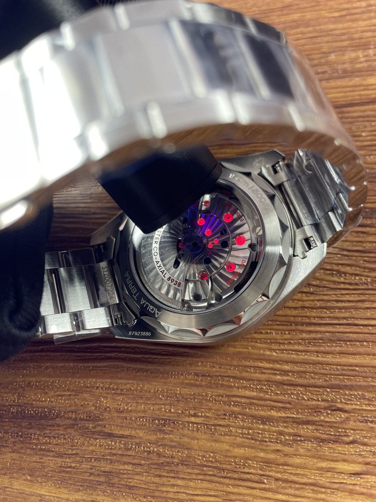 Illuminated transparent back of Worldtimer replica with 8938 barrel Aqua Terra 150m and code style marks