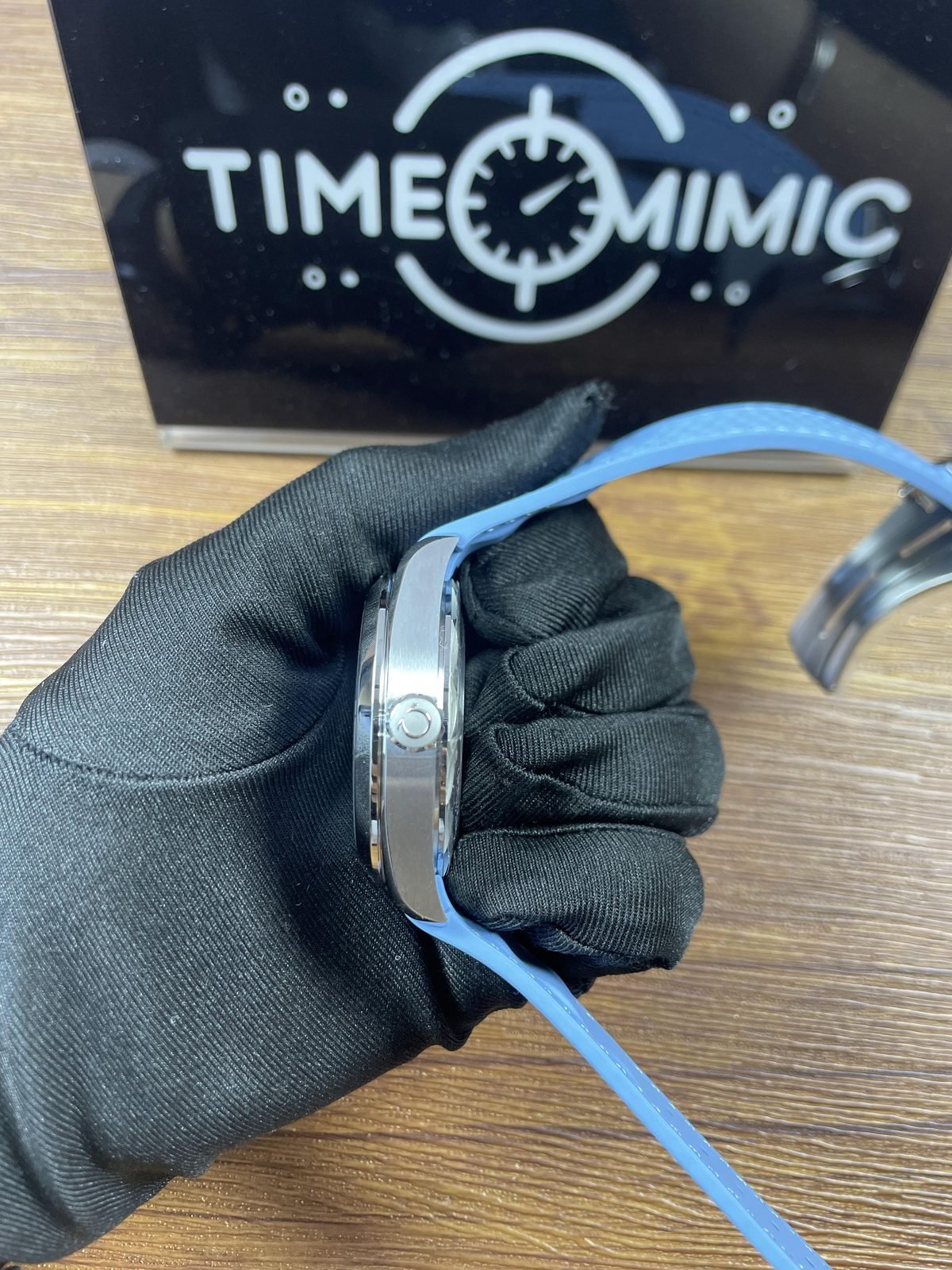 Crown side profile of Summer Blue Aqua Terra Worldtimer replica with steel tone case and integrated light blue strap