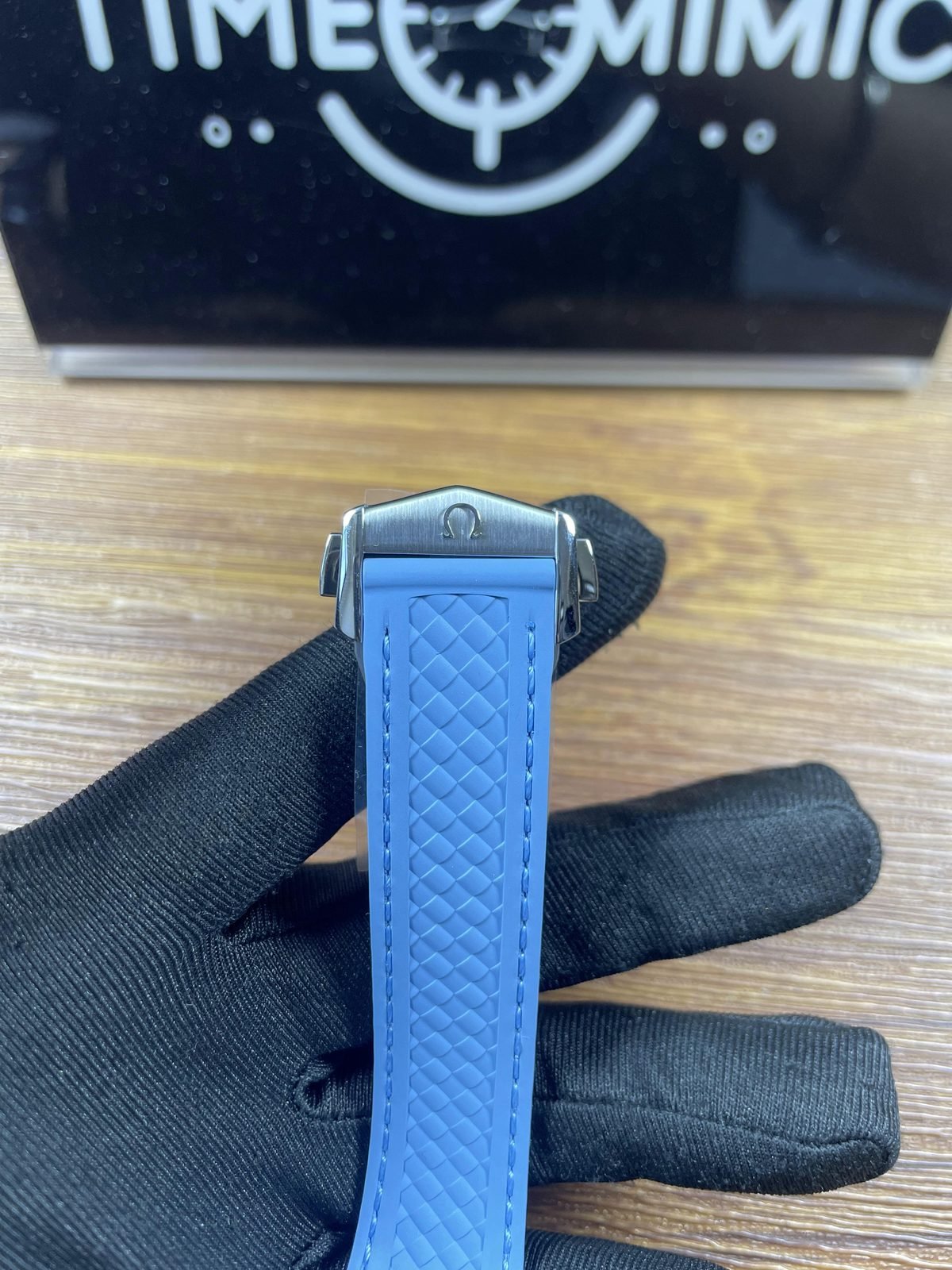 Steel tone foldover clasp exterior on light blue integrated strap of Worldtimer replica