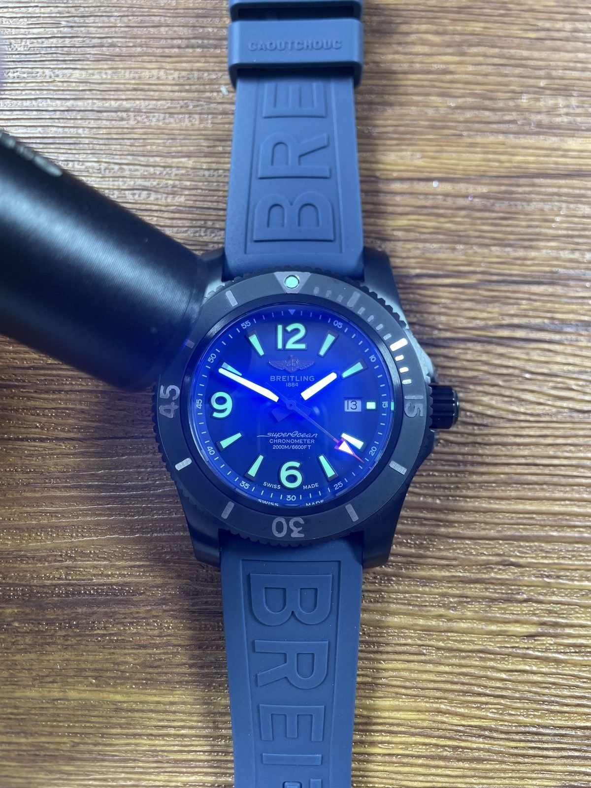 Breitling Superocean M17368D71C1S2 replica cyan green response under directed light